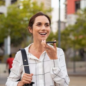 Woman talking on speaker phone while walking.